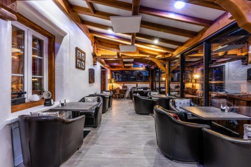 a row of tables and chairs in a restaurant at Logis Hôtel et Spa Le Christiania in La Salle-les-Alpes