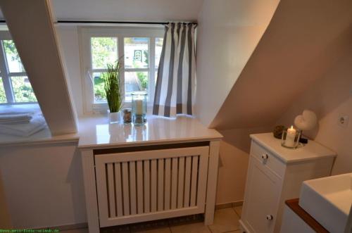 a small room with a table and a window at Deichhof - Whg3 in Dunsum