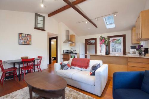 a living room with a white couch and a table at Berkeley Cottage, Comfy, Stylish Good Wi-Fi in Berkeley