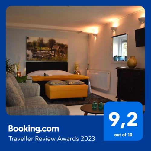 a bedroom with a bed and a couch and a table at BenB de Walvis in Krimpen aan de Lek