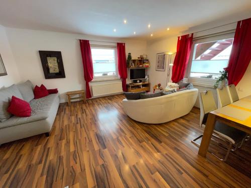 a living room with a couch and a table at Appartement Holiday in Maishofen