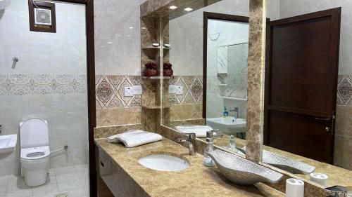 a bathroom with a sink and a toilet at Sunrise Farm استراحة مطلع الشمس in Hatta