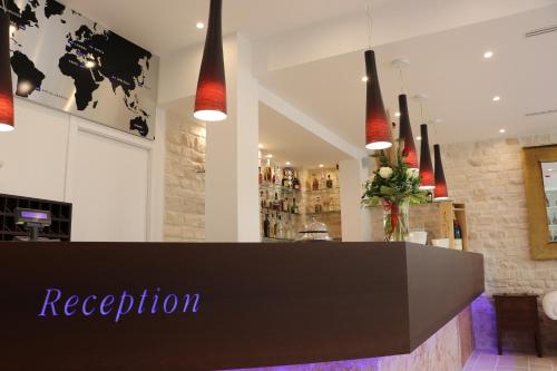 a restaurant with a reception desk in a room at Hotel Lafayette in Giovinazzo