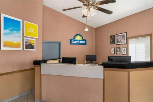 a view of a lobby with a desk with a ceiling fan at Days Inn by Wyndham Canastota Verona in Canastota
