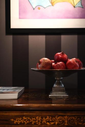 a plate of pomegranates sitting on a table at Savoy Hotel & Spa - Preferred Hotels & Resorts in Paestum