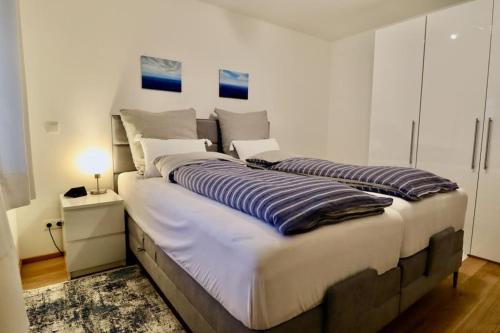 a large bed with two pillows on it in a bedroom at Modern Apartment, central in Bad Aibling in Bad Aibling