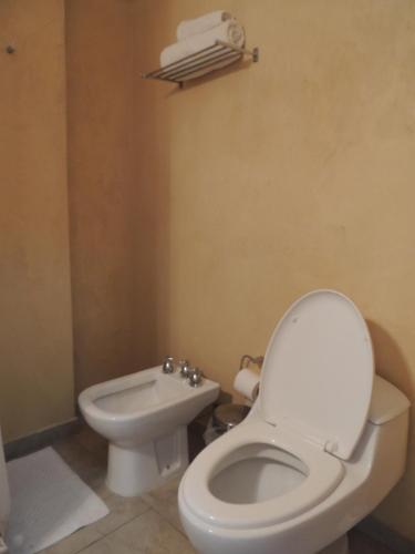 a bathroom with a white toilet and a sink at Park View Hotel & Residences in Campana