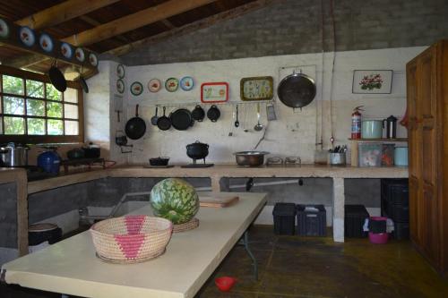 a kitchen with a table with a watermelon on it at Winterdodgers Backpackers and Campsite in Sodwana Bay