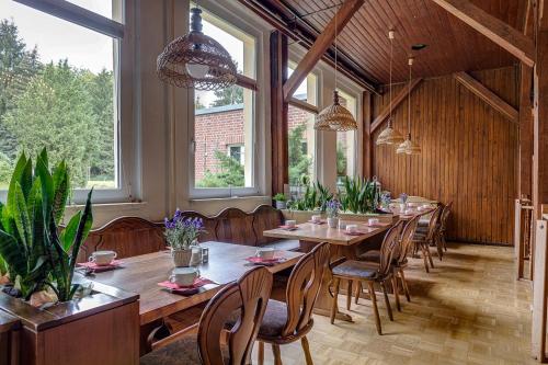 a large dining room with a long table and chairs at Waldhotel & Restaurant Stieglitzenkrug in Feldberg