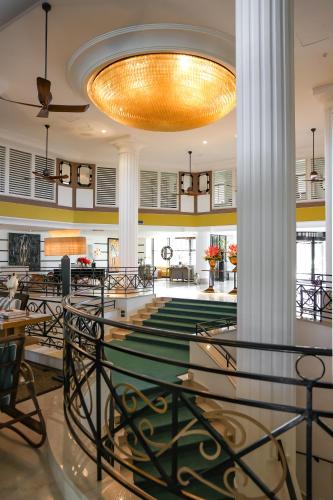 a large lobby with a chandelier and tables and chairs at Savoy Hotel & Spa - Preferred Hotels & Resorts in Paestum