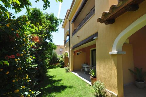 a garden outside a building with a grass yard at Hotel Il Girasole in Villasimius