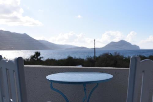 a blue table sitting on the side of a wall at Elia - Studios Amorgos - near the sea in Aegiali