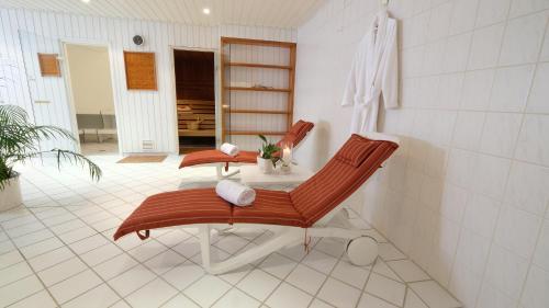 a room with two chairs and a table in a room at Landhotel Hubertus in Unterelsbach