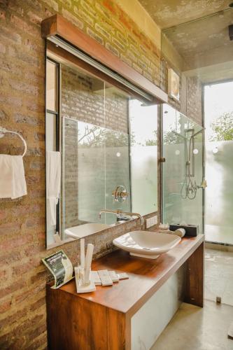a bathroom with a sink and a mirror at Kalundewa Retreat in Dambulla