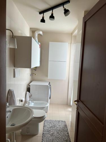 a bathroom with a white toilet and a sink at Les Deux Citrons in Limone Piemonte