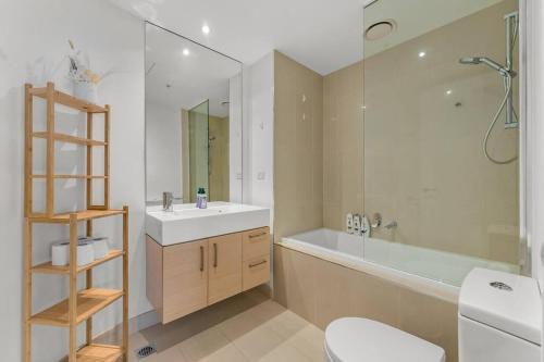 a bathroom with a sink and a tub and a toilet at Southbank CBD Apartment with Spectacular Views in Melbourne