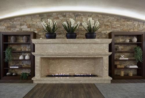 a stone fireplace with three plants on top of it at Buona Vitta Gramado Resort & Spa by Gramado Parks in Gramado