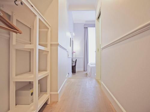 a hallway with white shelves in a room at Gemini Suites Navona in Rome