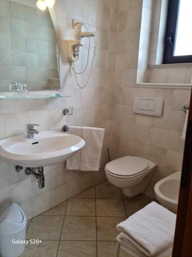 a bathroom with a sink and a toilet at Hotel Lido in Vasto