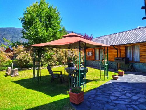 a gazebo in the yard of a house at Casa Puelo Hostería y Cabañas in Lago Puelo