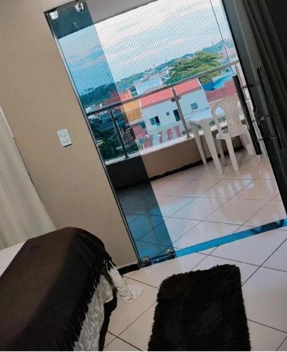 a room with a view of a room with a window at Pousada Central in São Benedito