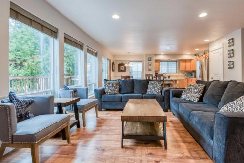 a living room with blue couches and a table at A Lobster Lookout in Lincoln City