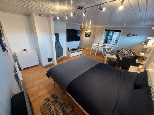 a large living room with a bed and a living room at In Love With Norway in Larvik