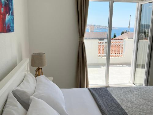 a bedroom with a bed and a large window at Apartments Mrdak in Bar
