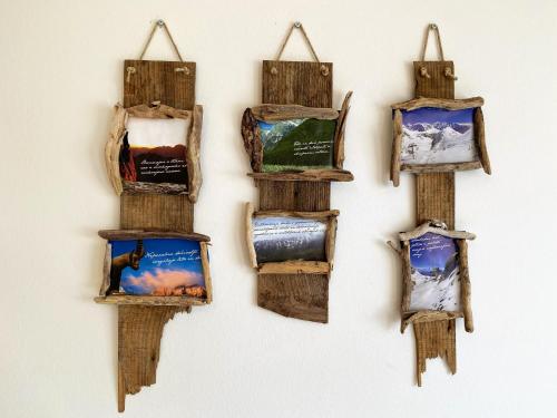 a group of wooden boxes hanging on a wall at Cozy Apartment Bovec in Bovec