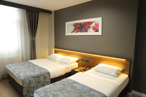 Postel nebo postele na pokoji v ubytování Turkuaz Hotel
