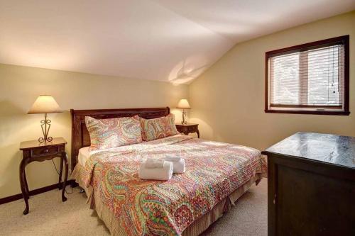 a bedroom with a bed and two lamps and a window at Excellent Townhome On Golf Course w/3 Bdrm 2 Bath in Mont-Tremblant