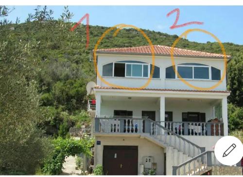 a house with orange circles on top of it at Cozy apartman in Luka