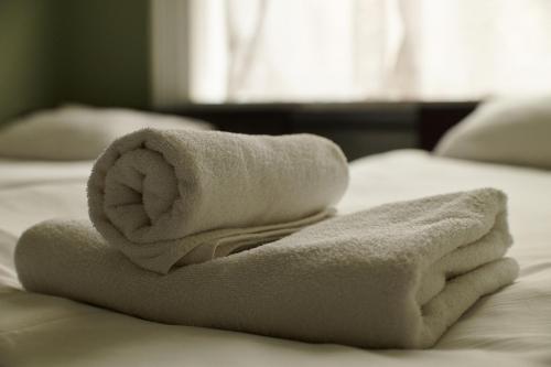 a pile of towels sitting on top of a bed at Old City Hostel in Lviv