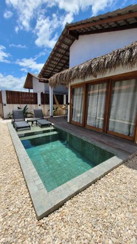 a small swimming pool in front of a house at BG Sol e Mar - Chalé Mar in Barra Grande