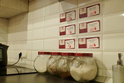 a row of glass jars on a counter in a kitchen at Old City Hotel in Lviv