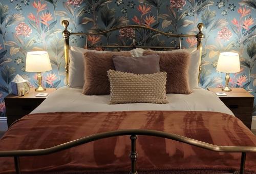 a bedroom with a large bed with two lamps at The Florence Guest House in Whitby