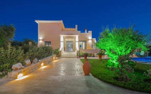 a house with a pathway leading to the front door at Romanza Luxury Villa in Kalamaki