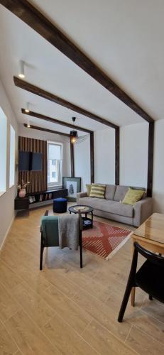 a living room with a couch and a table at Randevu Nivalis in Jahorina