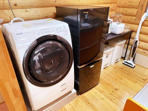 a washer and dryer sitting next to a microwave at Tabino Hotel Villa Miyakojima in Miyako Island