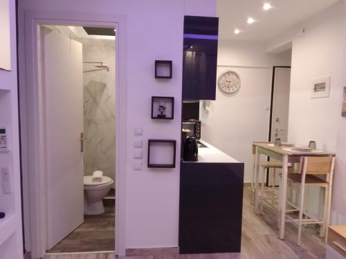 a bathroom with a sink and a toilet in a room at Petit Apartment - City Center - GORGOPOTAMOU 1 in Veria