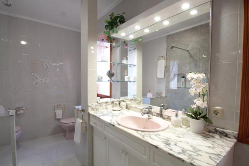 a bathroom with a sink and a toilet and a mirror at Villa Capllonch in Banyalbufar