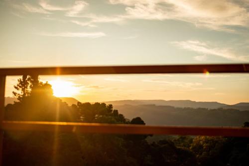 a view of the sunset from a train window at Condomínio Familiar - Aptos Novos e Completos in Nova Petrópolis