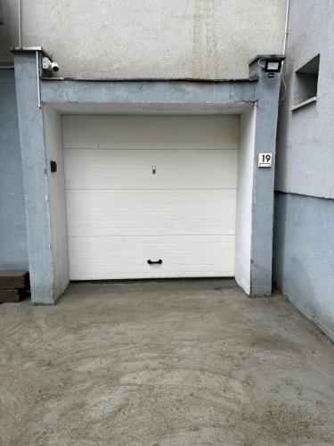 a large white garage door in a building at ESI Apartments #Central with Garage in Timişoara