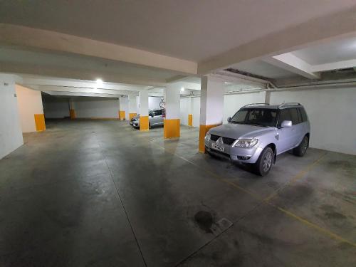 a parking garage with a car parked in it at Condomínio Familiar - Aptos Novos e Completos in Nova Petrópolis