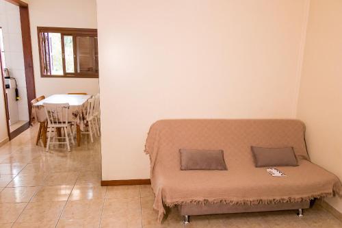 a bed in a room with a table and chairs at Condomínio Familiar - Aptos Novos e Completos in Nova Petrópolis