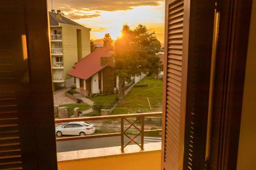a view from a window of a street with a car at Condomínio Familiar - Aptos Novos e Completos in Nova Petrópolis