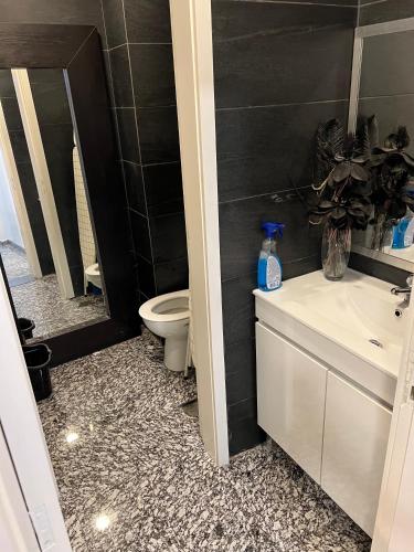 a bathroom with a white sink and a toilet at Modern & Central 3 minutes from the River in Vila Nova de Gaia