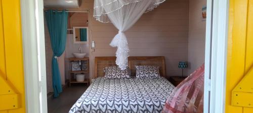 a bedroom with a bed in a room at Gwadakaz in Sainte-Rose