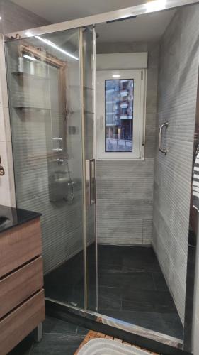 a shower with a glass door in a bathroom at Apartament Melpomeny in Tarragona