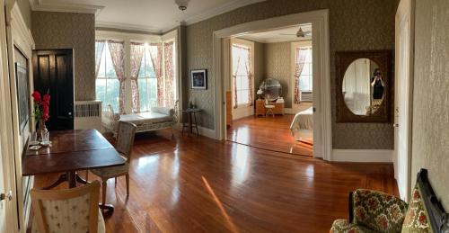 a living room with a hard wood floor and a table at The Wedding Cake House in Providence